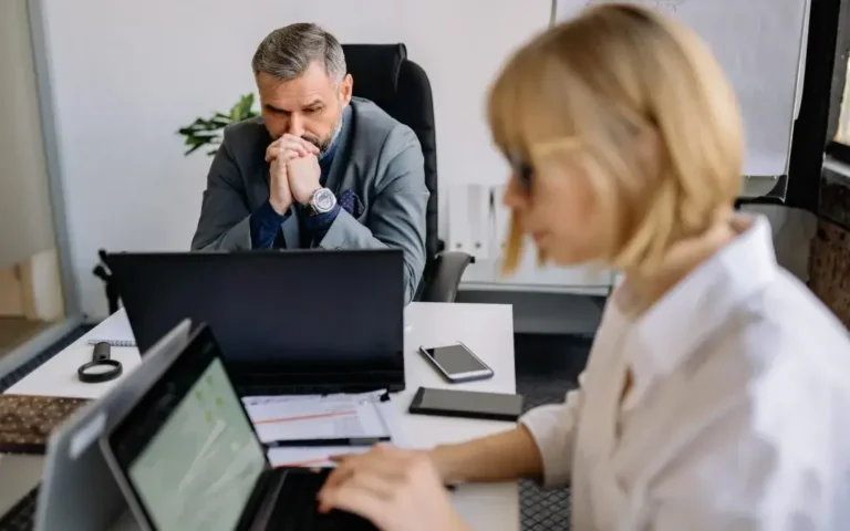 Co-workers working on financial statements in the uk
